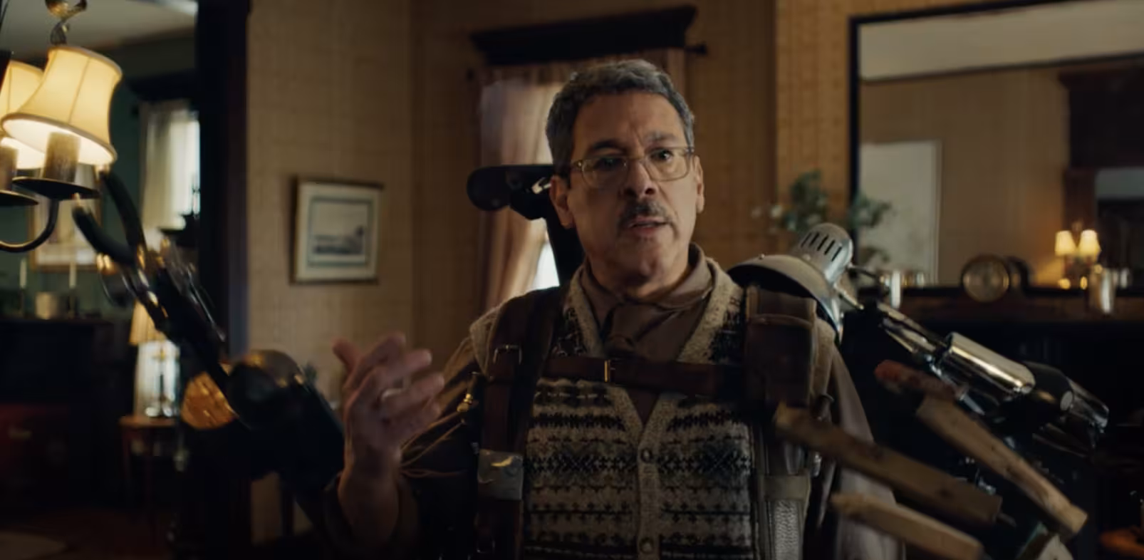 A man with several hand-like apparatuses attached to himself