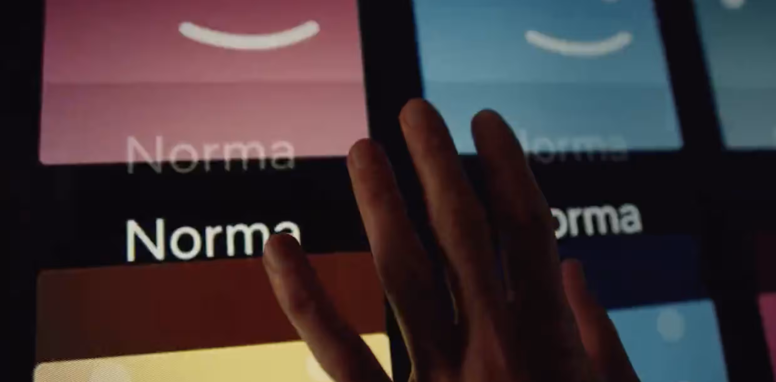 A hand scrolls through a list of Netflix profiles called Norma