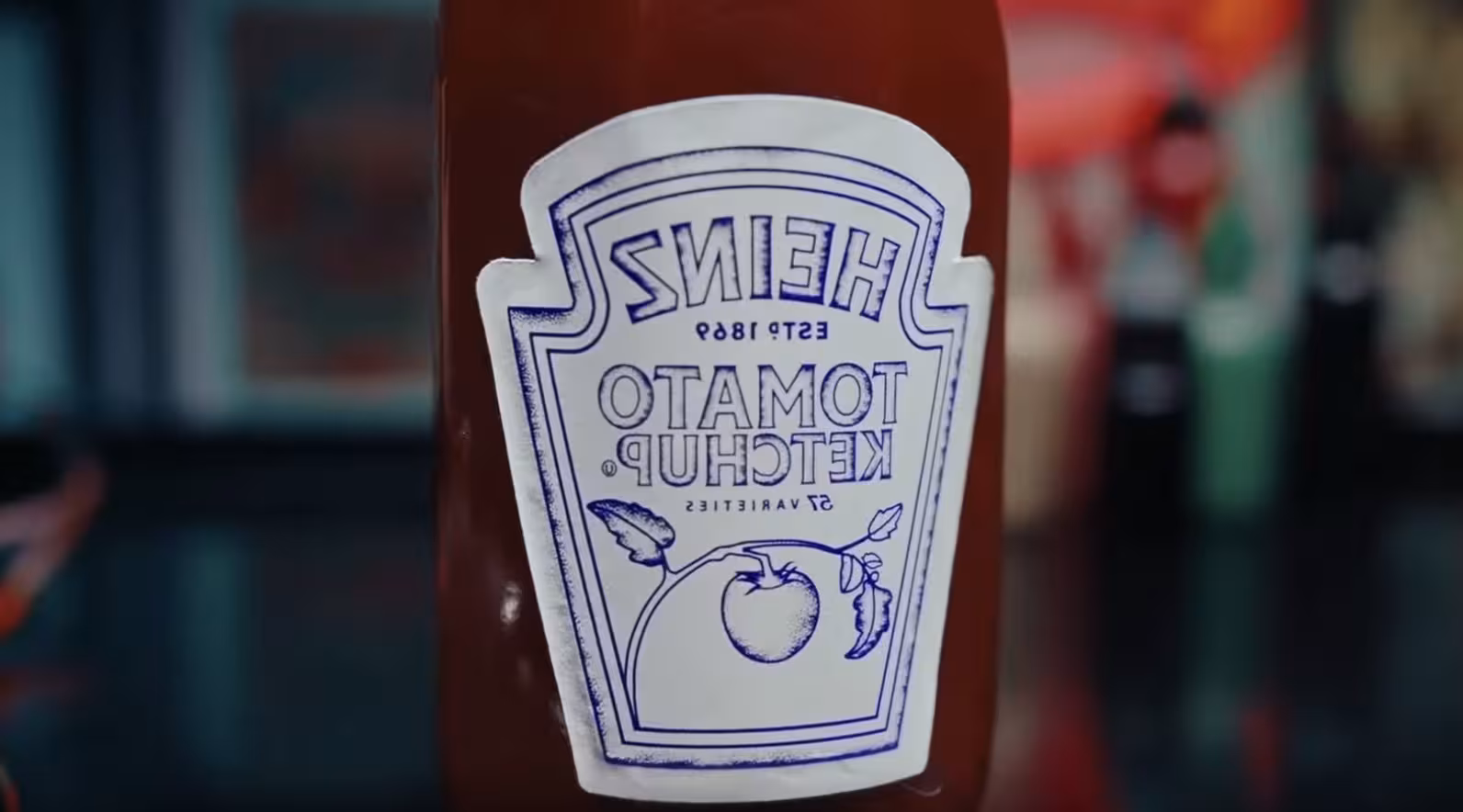 The Heinz Ketchup label appears backwards on the bottle in purple ink like a tattoo stencil
