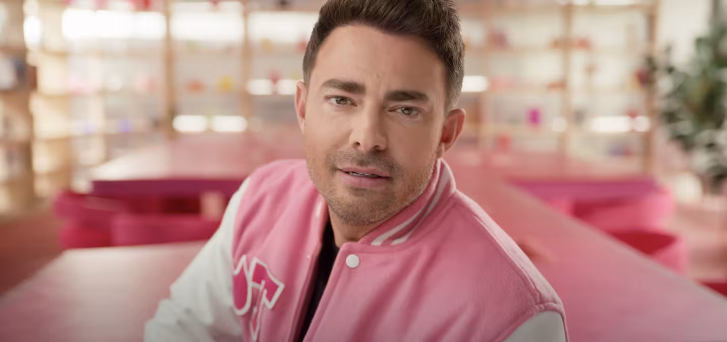 Jonathan Bennett in a pink letterman jacket